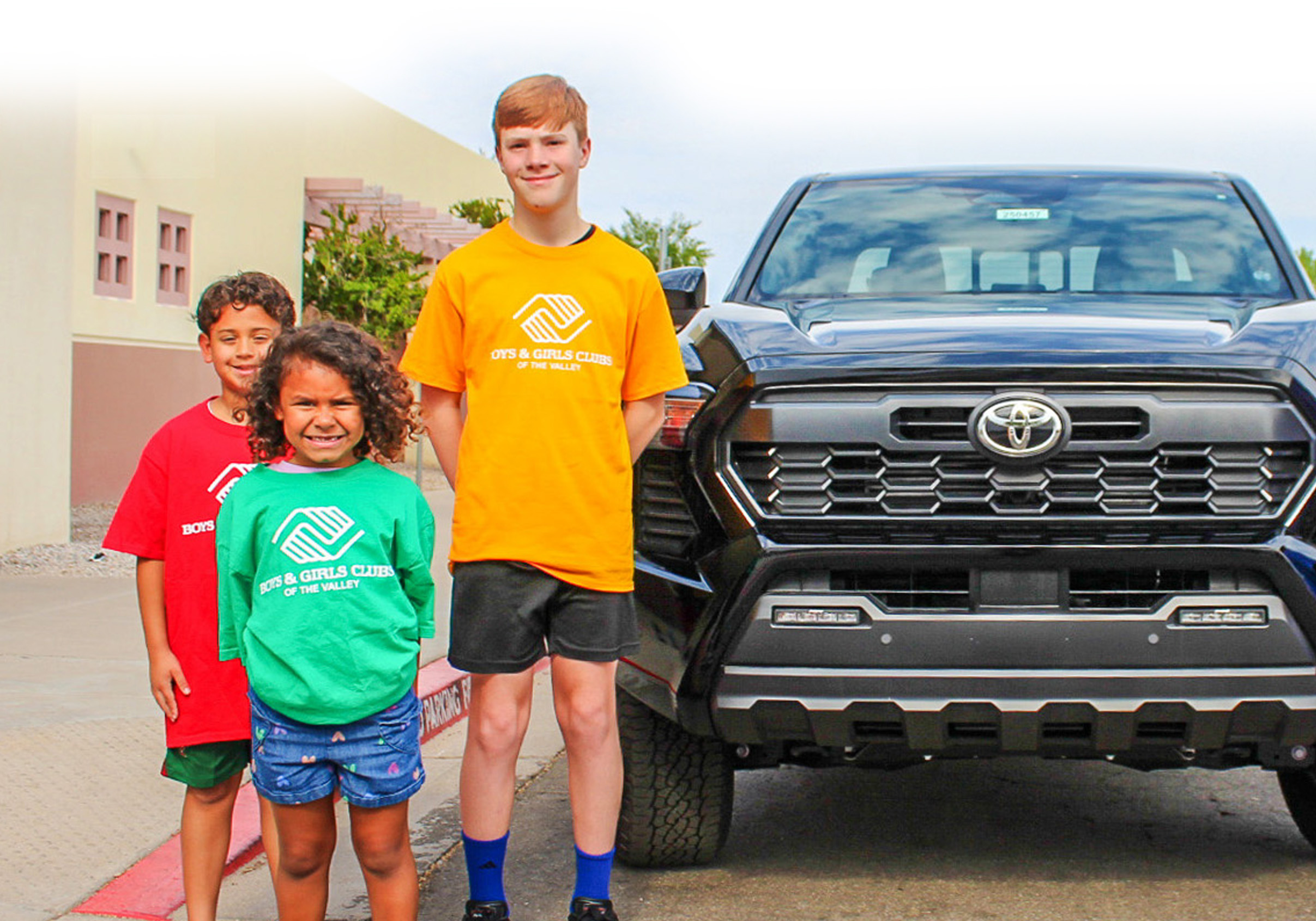 3 BGCAZ youth in front of Toyota Tacoma
