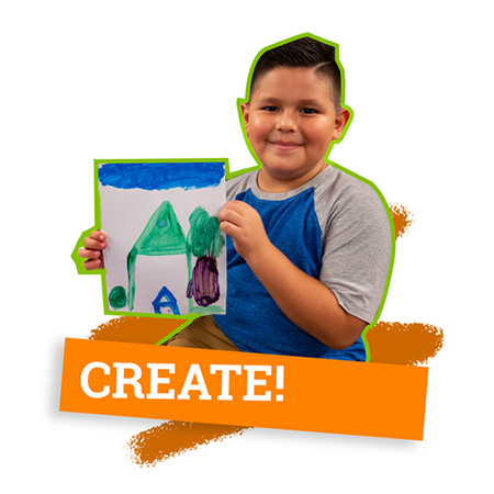 Smiling boy holding up handmade artwork